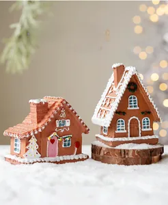 Macro detail of miniature resin gingerbread houses with faux snow and festive bokeh lights