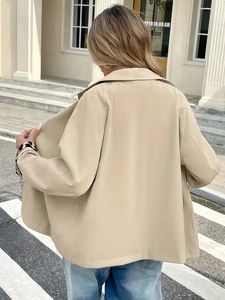 Detail of beige jacket with leopard print cuff lining and elegant lapel design