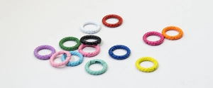 Colorful twisted alloy spring ring hooks in various vibrant shades on white surface