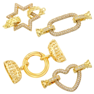 Detailed close-up of gold-plated brass jewelry clasps with zircon heart and star shapes