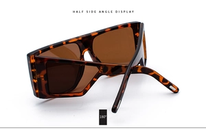 Detail shot of oversized tortoise shell sunglasses with gradient brown lenses