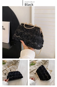 Detail view of a black 3D rose evening clutch with gold metal handle and luxury diamond clasp