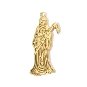 Macro shot of gold-plated stainless steel reaper pendant with scythe and scales detail