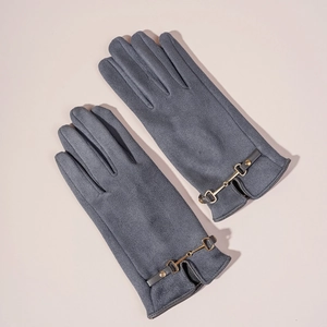 Detailed view of dark grey suede gloves with elegant golden metal horsebit buckle accents