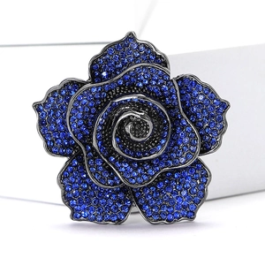 Close-up of vintage dark blue rhinestone rose brooch with black metal plating finish