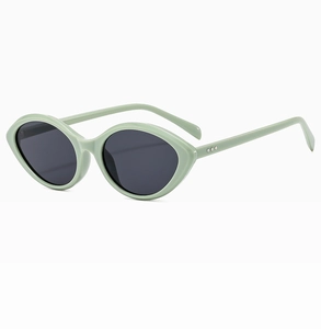 Detail view of oval cat-eye sunglasses in mint green with silver rivet accents
