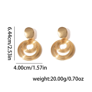 Detail view of gold circular geometric earrings showing dimensions 6.44cm by 4.00cm