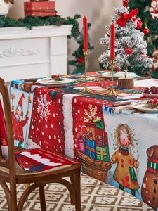 Close-up of Christmas tablecloth and chair covers with festive Santa and snow scenes