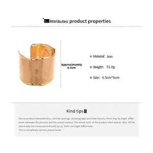Detail view of gold wide cuff bracelet with wavy edges and irregular texture specifications