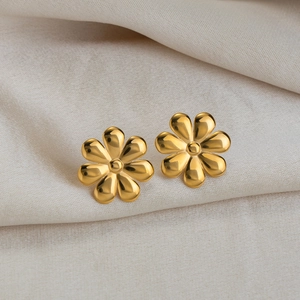 Minimalist 18K gold plated flower earrings on beige fabric background for women