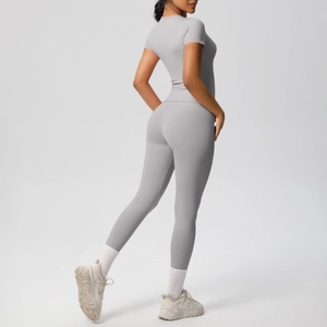 Detail of light grey seamless yoga set showing high waist leggings and slim fit t-shirt