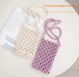 Detail of hand-woven crochet mobile phone bags in cream and purple with mesh texture