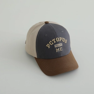 Detail view of tri-color kids baseball cap featuring embroidery and cotton canvas texture