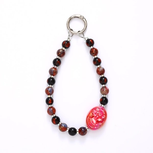 Handmade beaded keychain with red cameo portrait bead and metallic spring clasp on white background