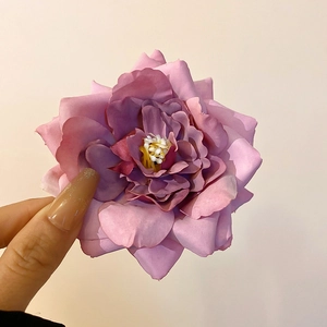 Macro detail of purple gradient fabric rose hair clip petals with realistic texture