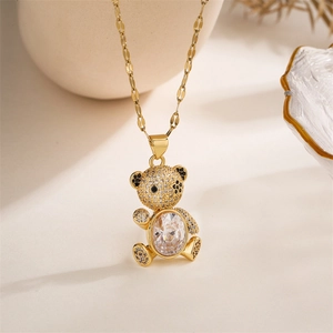 Macro view of gold teddy bear pendant with micro-pave crystals and oval gemstone