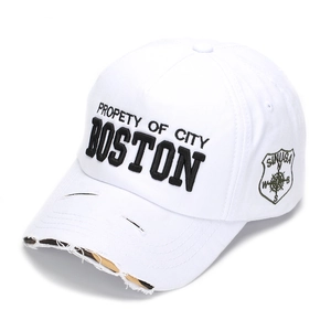 Detailed view of distressed white baseball cap with Boston embroidery and camo brim accents