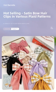 Detail of satin plaid bow hair clips in various colors with elegant flowing ribbons