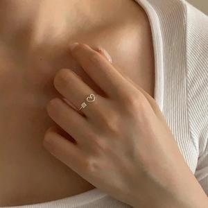 Macro detail of silver heart-shaped adjustable ring featuring a square-cut zircon stone