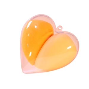 Dual gradient yellow makeup sponges in a clear heart-shaped storage case with hook