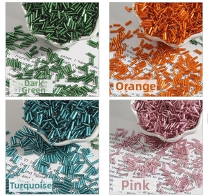 Detailed view of 2x7mm silver-lined glass bugle beads in four vibrant assorted colors