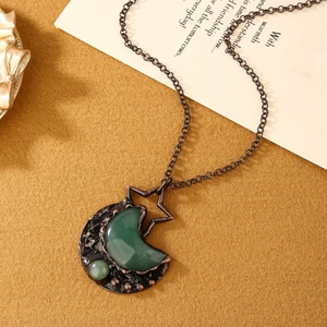 Close-up of vintage moon and star pendant with green aventurine gemstone and bronze chain