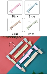 Macro shot of non-slip adjustable pants hangers in pink, blue, beige and green pastel colors