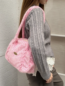 Detail der rosa Plüschtasche mit Leopardenmuster, Kunstfell und Metall-Logo-Schild