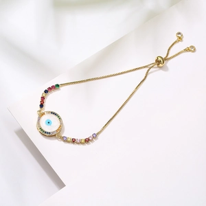 Evil eye bracelet with colorful cubic zirconia and adjustable slide closure on white background