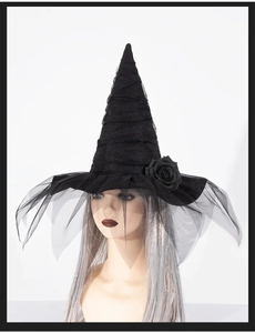Detail of black baroque witch hat with faux roses and gothic mesh veil on model