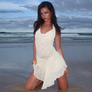 Detail of hollow knit lace texture on a backless halter mini dress with irregular hemline