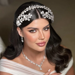 Detailed set of silver bridal headband, necklace and earrings with sparkling rhinestones