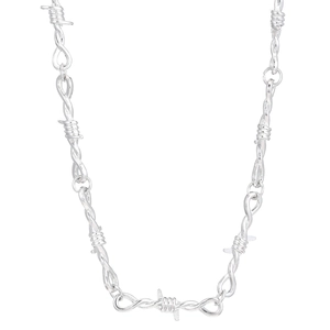 Macro detail of silver thorn barbed wire choker chain with punk metallic texture