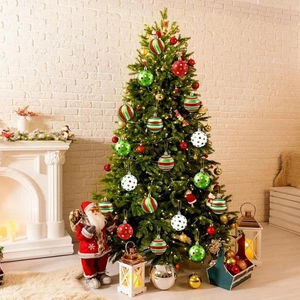 Classic red and green striped Christmas balls hanging on an indoor holiday tree