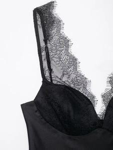 Gros plan détaillé sur la dentelle cil délicate et le satin mat d'un caraco noir élégant