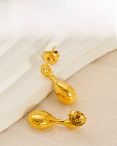 Close-up of 18K gold-plated teardrop earrings with a polished mirror finish detail