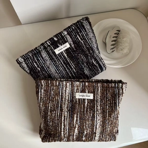 Detailed view of woven fabric texture and Simple Wish label on vintage denim cosmetic bags