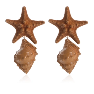 Detailed close-up of handmade starfish and seashell drop earrings in natural brown tones