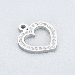 Macro detail of silver heart pendant with sparkling rhinestones and top hanging loop