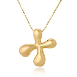 Detailed view of polished gold abstract cross pendant on thin box chain necklace