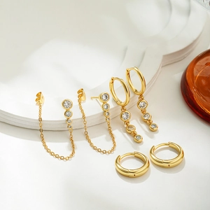 Detail view of 18K gold plated earring set with sparkling white zircon on geometric stand