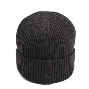 Detail of heavy ribbed knit texture and wide cuff on a solid black warm winter beanie