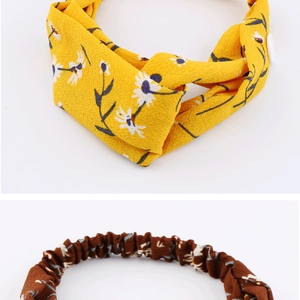 Close-up of chiffon daisy headbands with buttons and floral elastic fabric details