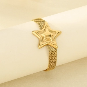 Detail of golden mesh watchband bracelet featuring a large 3D pentagram star charm