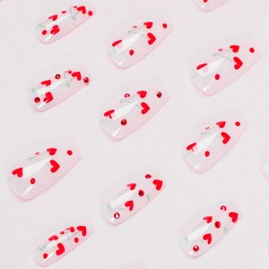 French style cherry and heart press-on nails with red rhinestones on translucent pink base