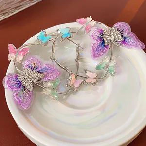 Elegant silver hoop earrings featuring purple embroidered butterflies and crystal accents