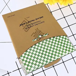 Greaseproof green checkered burger paper with kraft sandwich packaging on a grid background