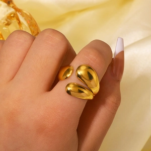Elegant gold teardrop geometric open ring in stainless steel for women on silk background