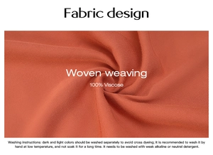 Macro detail of orange 100% viscose woven fabric texture and washing instruction labels
