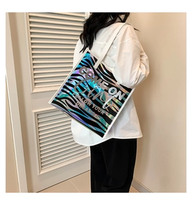 Close-up of holographic zebra print tote bag with COME ON Girl slogan and white straps